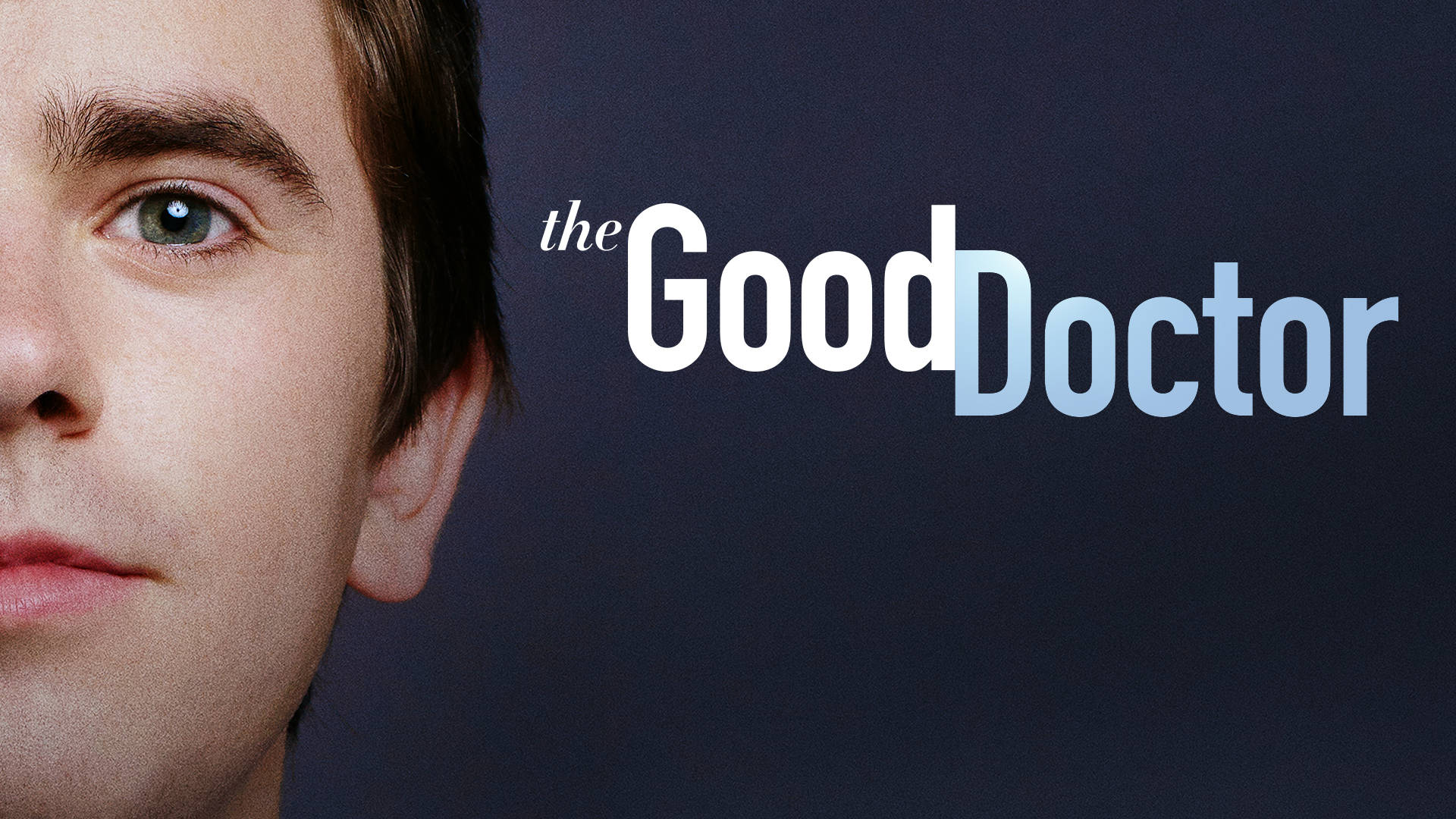 The Good Doctor 桌布 壁紙 — 近距離肖像，一個眼神強烈的男人旁邊有標題「the Good Doctor」，以粗體白色和藍色文字顯示在深色背景上。
