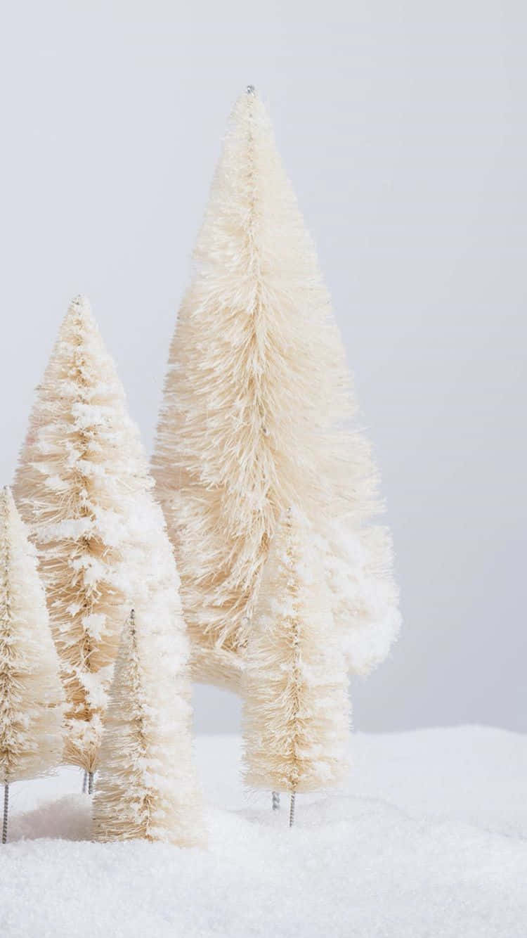 White Christmas iPhone 桌布 壁紙 — 迷你奶油色瓶刷樹立在柔軟的白雪中，背景為淺灰色。