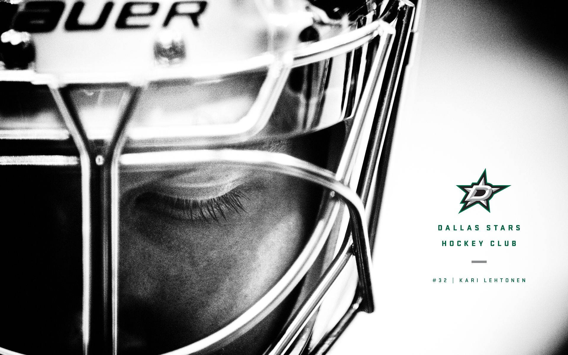 Dallas Stars 桌布 壁紙 — 達拉斯星隊標誌和名牌的曲棍球守門員面具下眼睛的特寫黑白肖像。