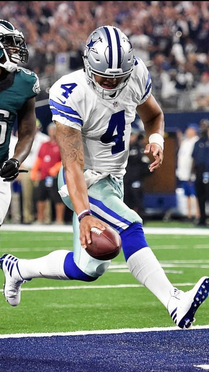 Dak Prescott 桌布 壁紙 — 達拉斯牛仔隊四分衛4號在體育場燈光下，於高風險的NFL比賽中持球衝刺。