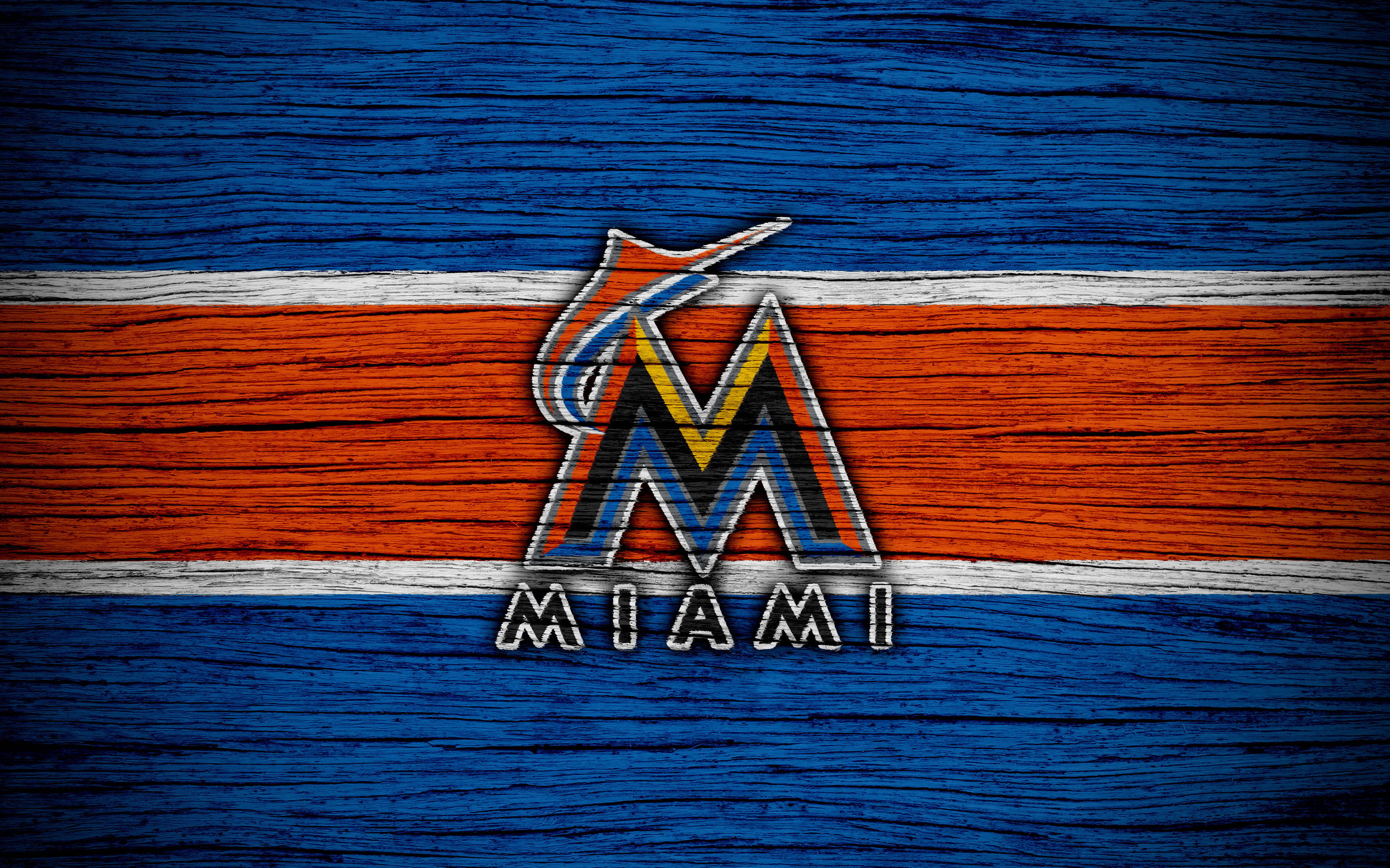 Marlins 桌布 壁紙 — 邁阿密馬林魚標誌繪在風化的藍色和橙色木板上，帶有白色條紋。