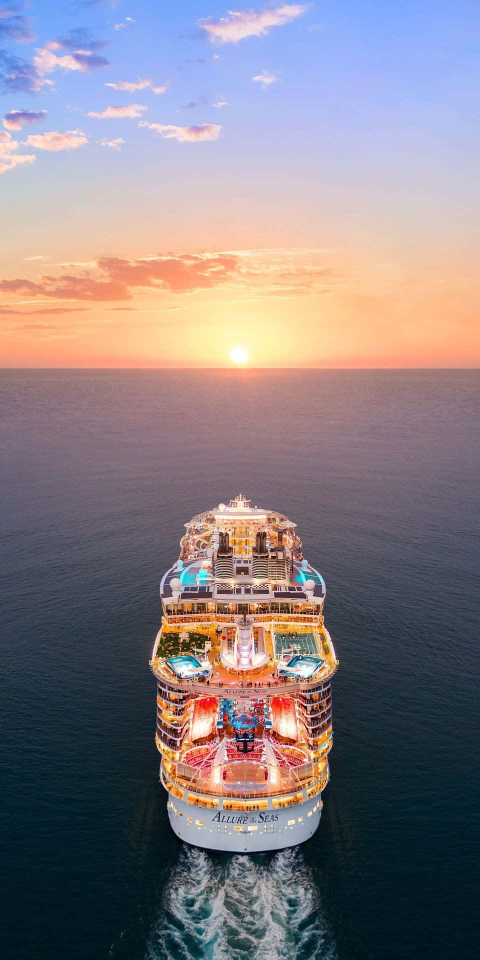 Cruise 桌布 壁紙 — 郵輪Europa 2在日落時分航行，甲板閃耀，海面平靜的航拍視角。