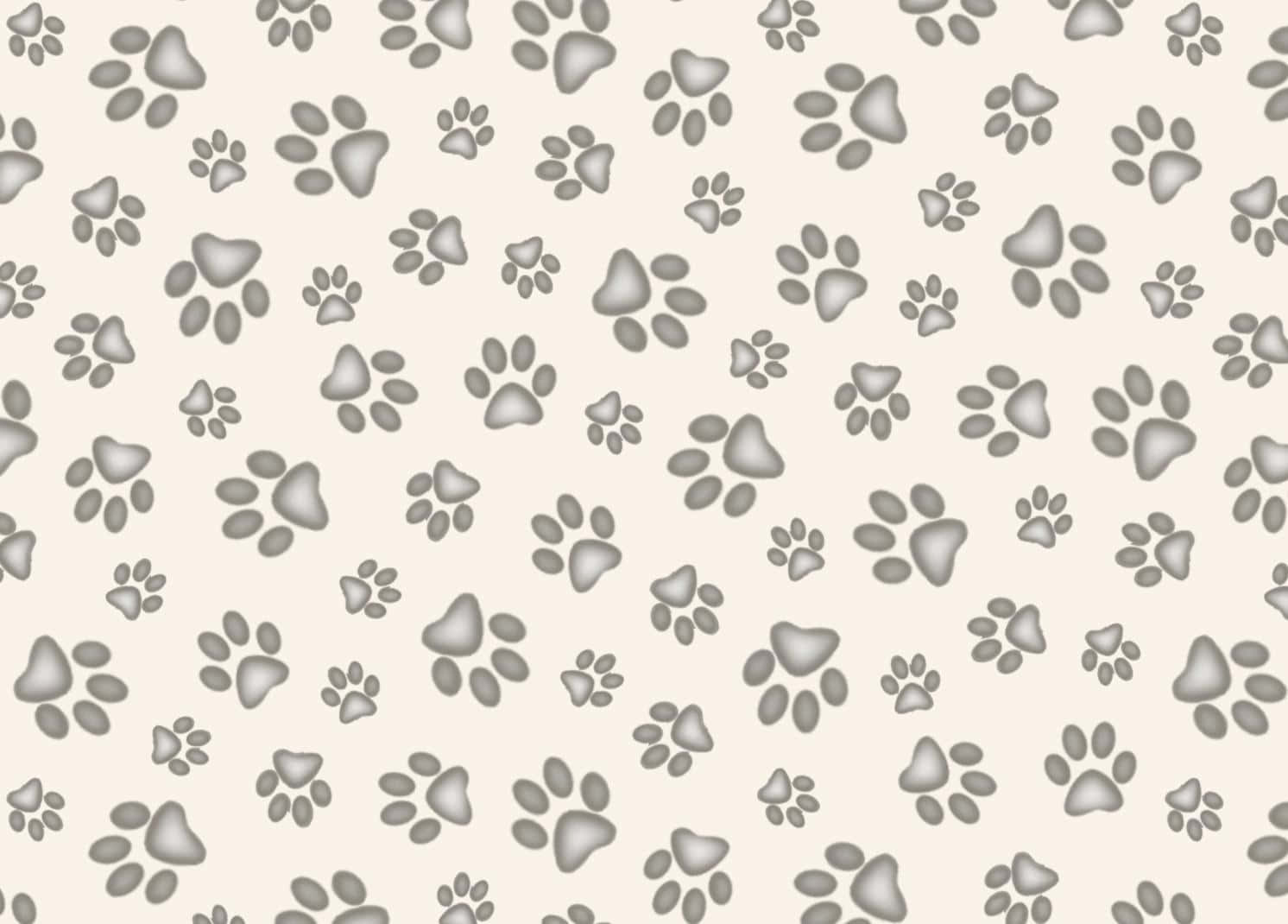 Paw Print 桌布 壁紙 — 重複的灰色爪印散落在柔軟的米色背景上，形成俏皮的圖案。