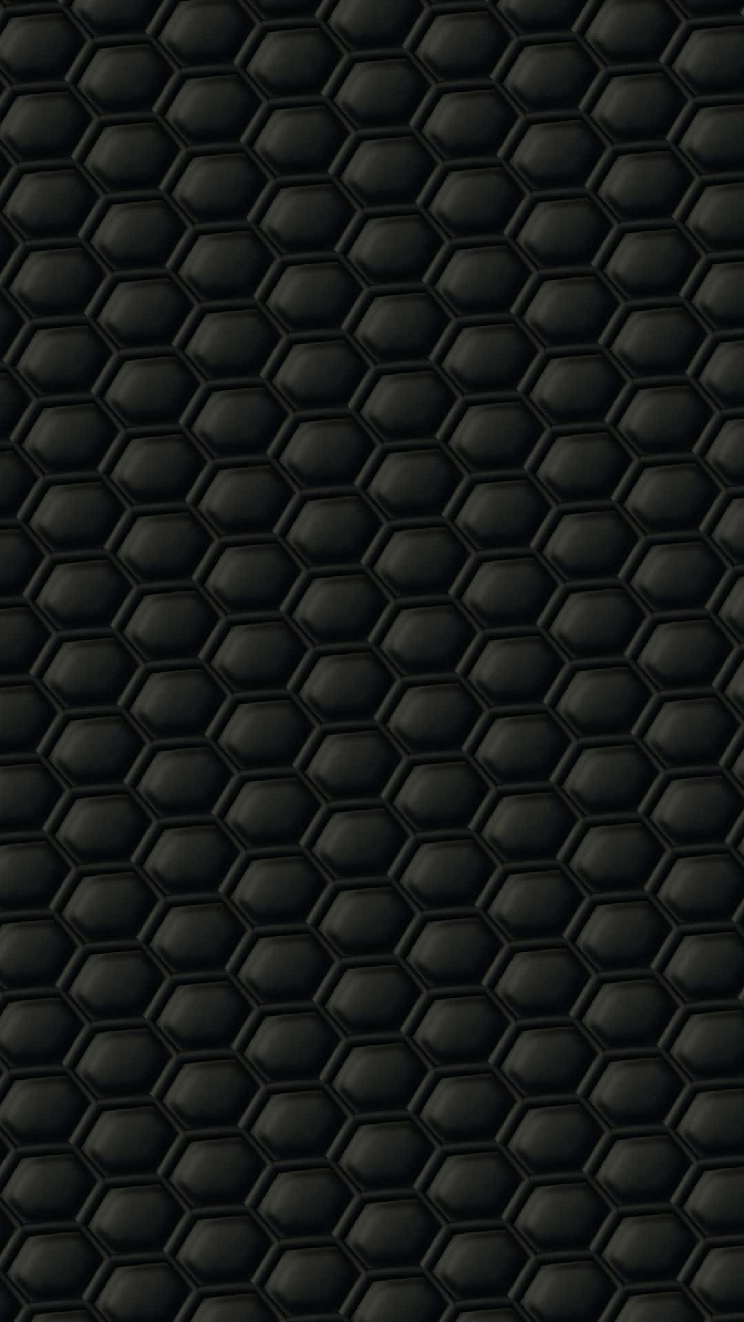 Hexagon 桌布 壁紙 — 重複黑色六邊形紋理的近距離特寫，帶有微妙的陰影，營造出現代幾何圖案。