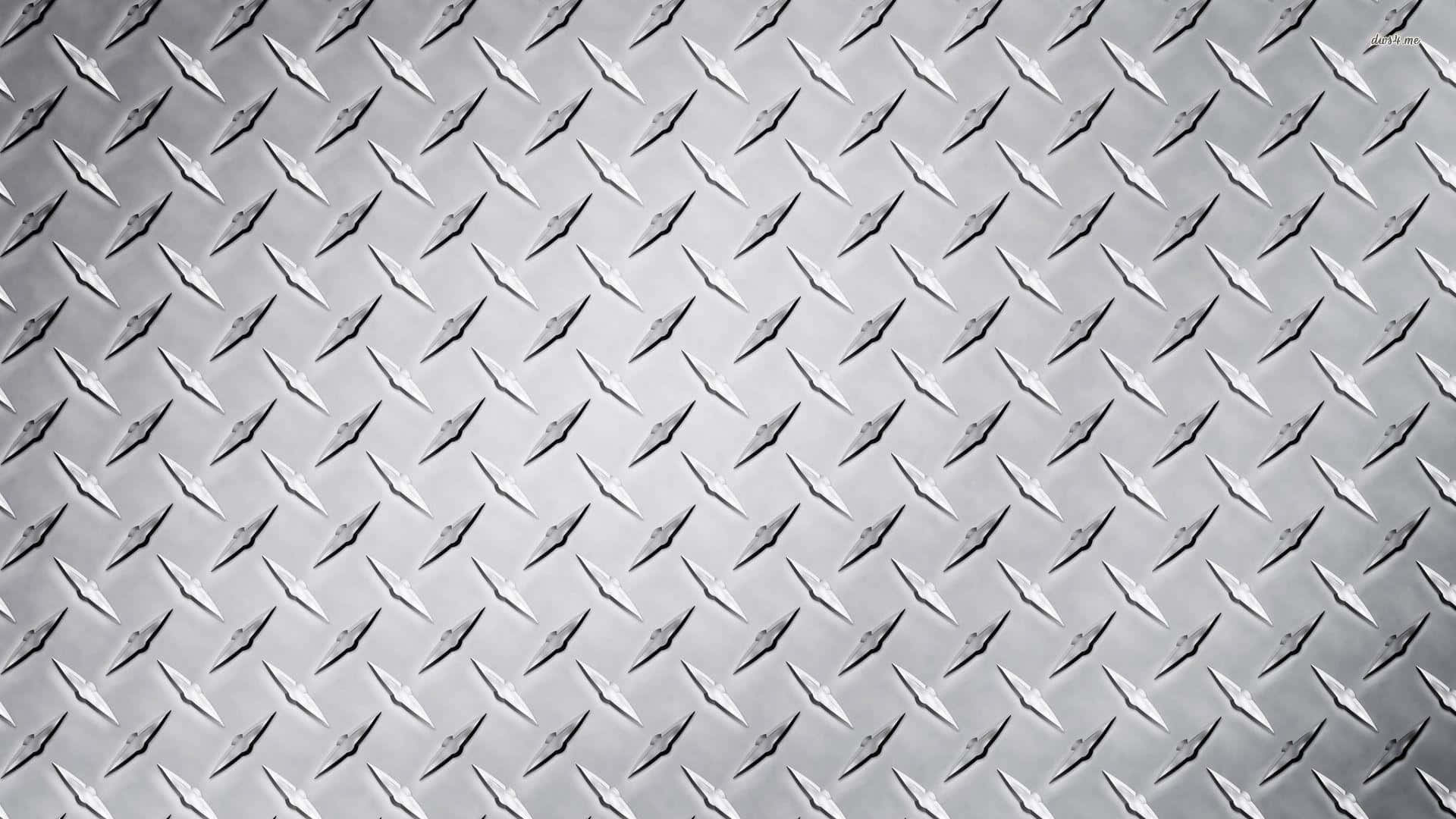 Diamond Plate 桌布 壁紙 — 金屬菱形板表面的特寫，帶有重複的凸起菱形圖案和微妙的灰色高光。
