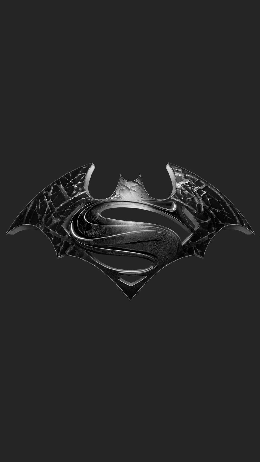 Batman Logo 桌布 壁紙 — 金屬蝙蝠標誌與 'S' 徽章融合，背景為深灰色。