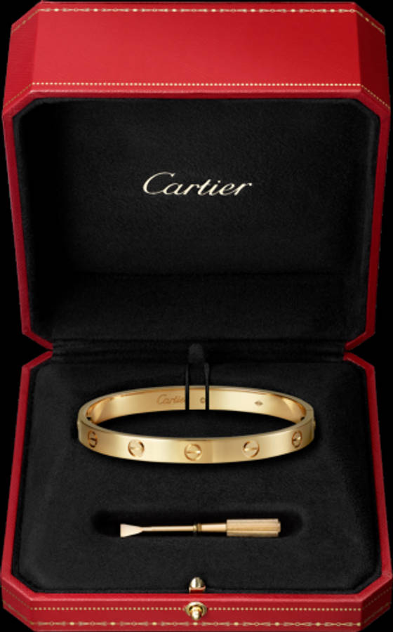 時尚 桌布 壁紙 — 金色Cartier love手鐲在一個配有黑色天鵝絨襯裡和配套工具的豪華紅色盒子中閃耀。