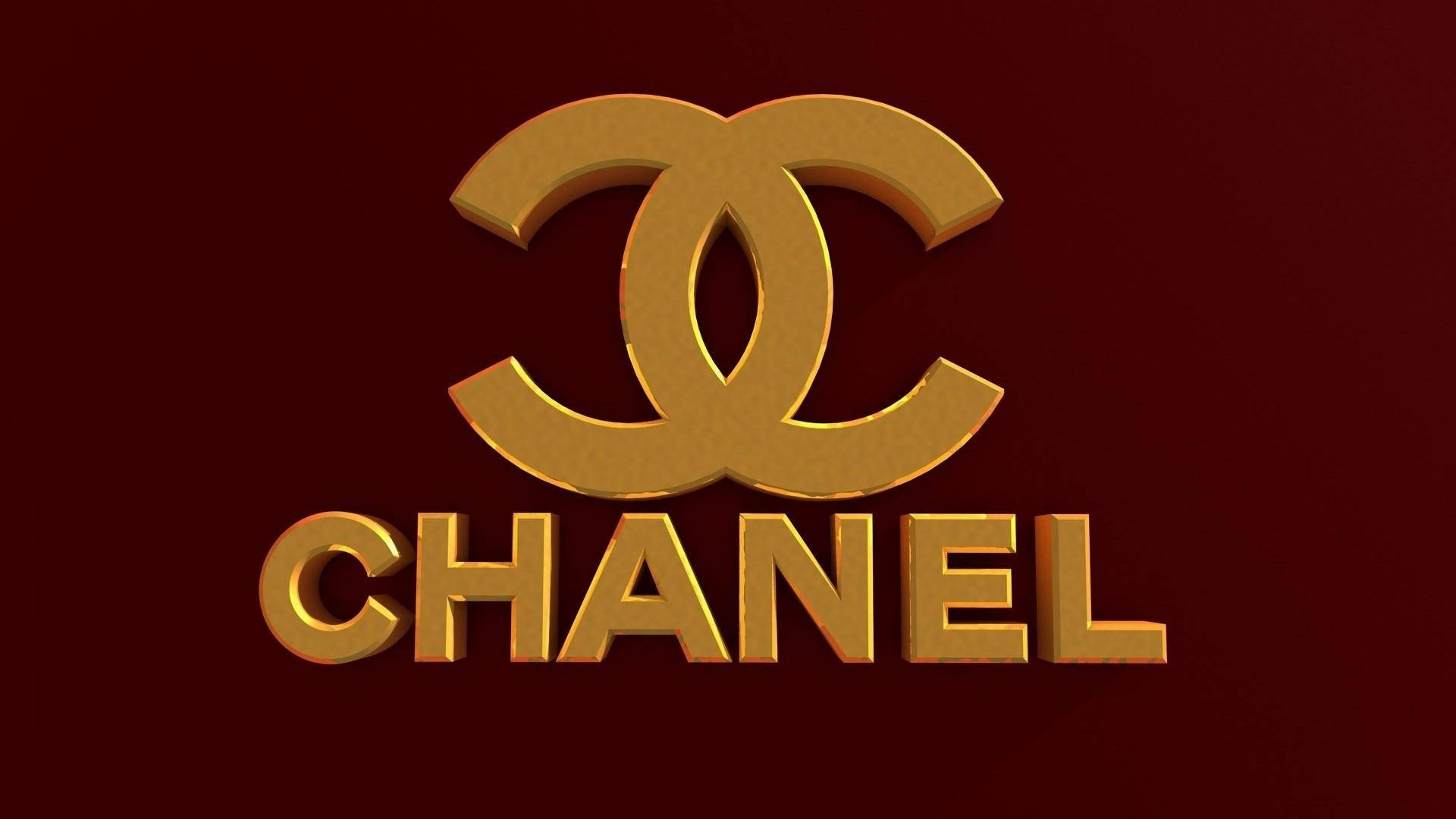 Pink Chanel Logo 桌布 壁紙 — 金色Chanel標誌，帶有交織的C和品牌名稱，在濃郁的酒紅色背景上脫穎而出。