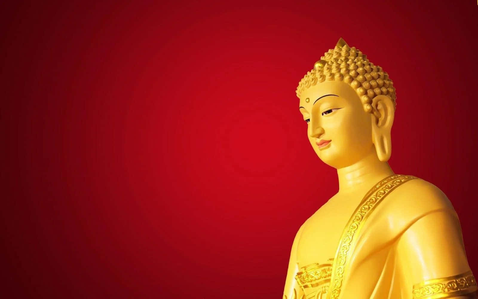 Gautama Buddha 桌布 壁紙 — 金色佛像以寧靜的側面輪廓呈現，背景為豐富的紅色漸變。