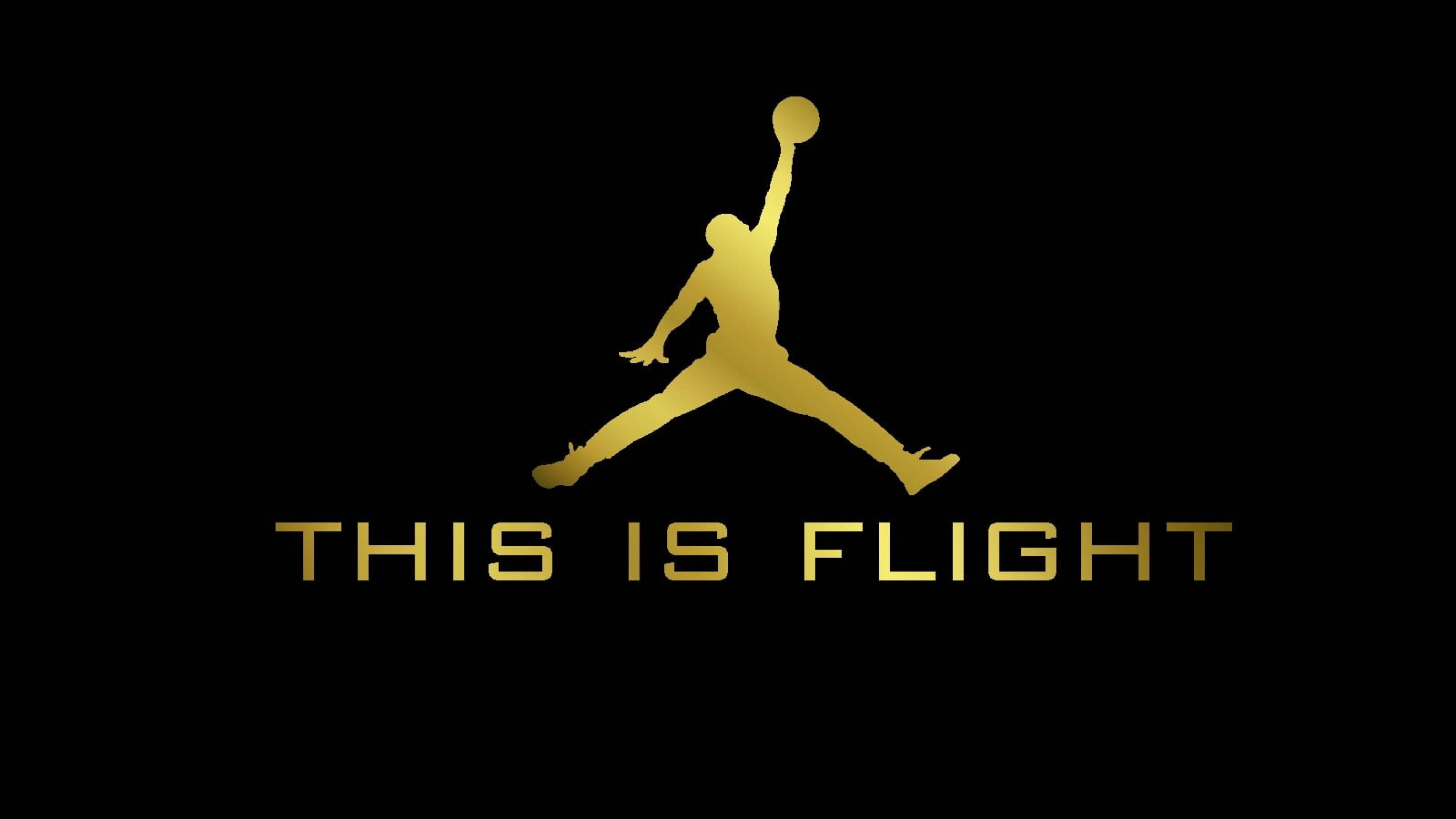 Air Jordan 桌布 壁紙 — 金色剪影，一個籃球運動員在半空中持球，黑色背景，下方有文字「THIS IS FLIGHT」。
