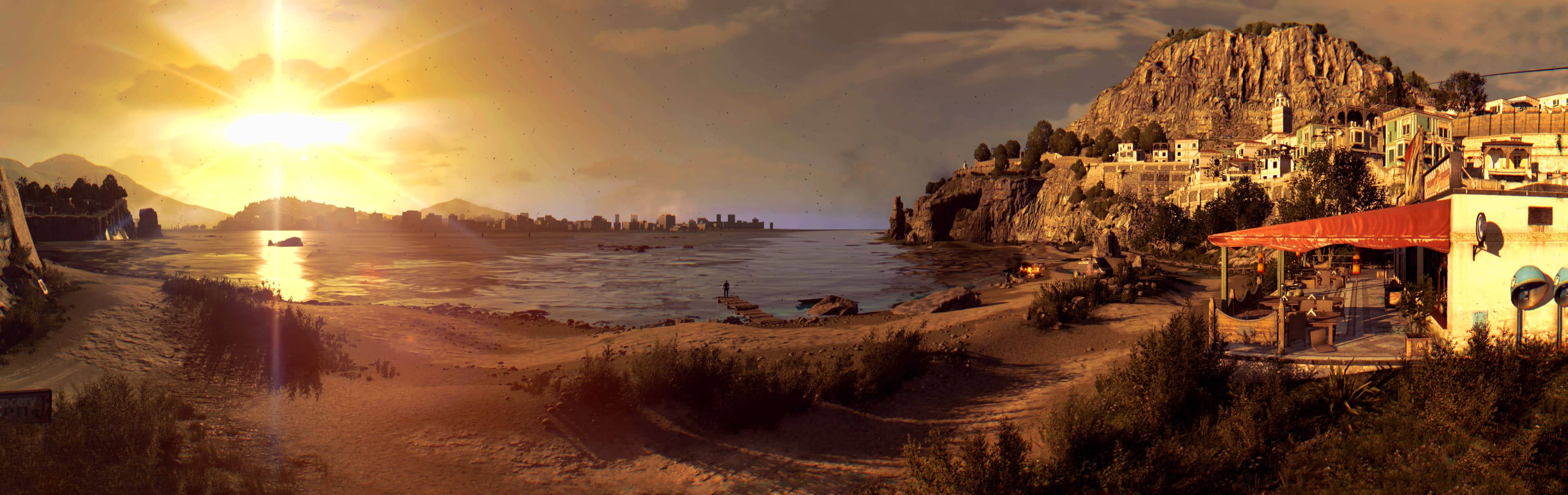 Dying Light 桌布 壁紙 — 金色夕陽沐浴著坐落在懸崖上的沿海村莊，平靜的海面和遠處的山脈在溫暖的光芒下。