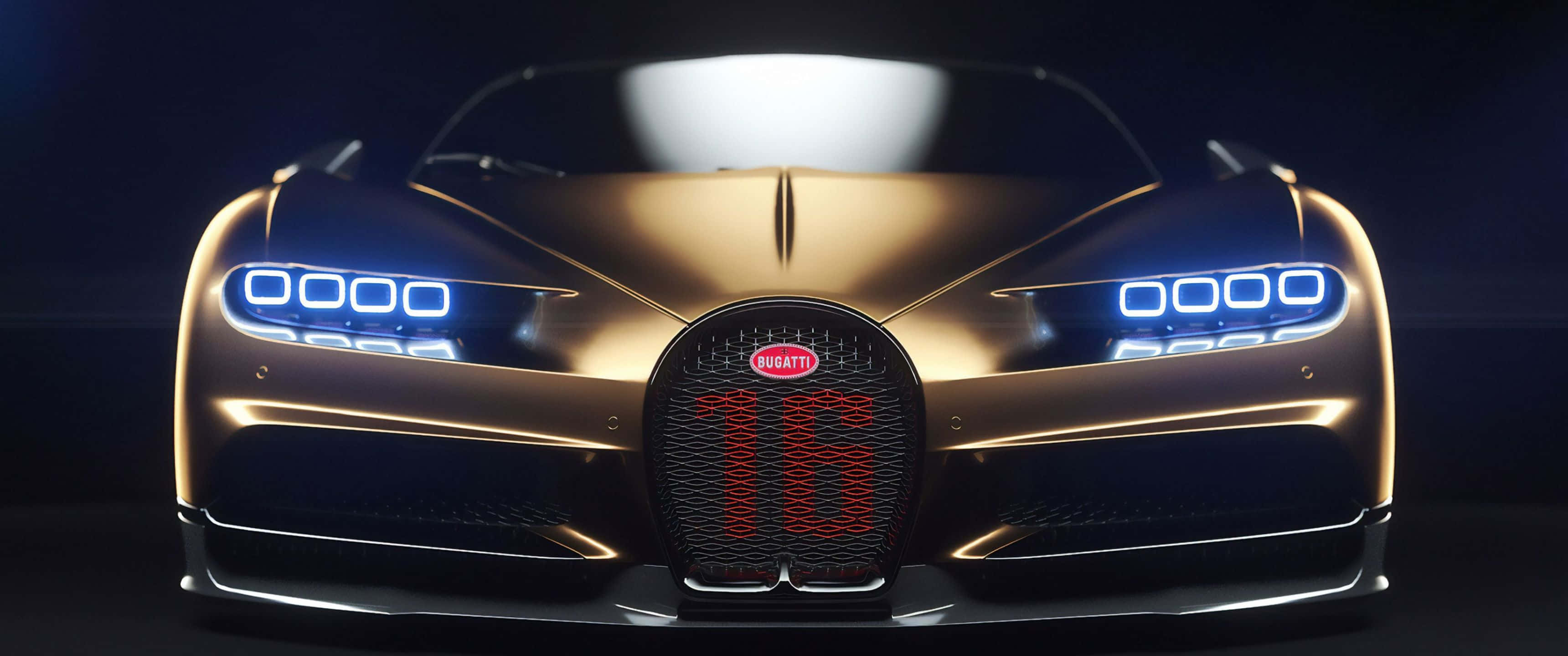 3440x1440p Bugatti 桌布 壁紙 — 金色布加迪超跑，配備發光藍色頭燈和紅色「16」格柵徽章，背景為深色工作室。