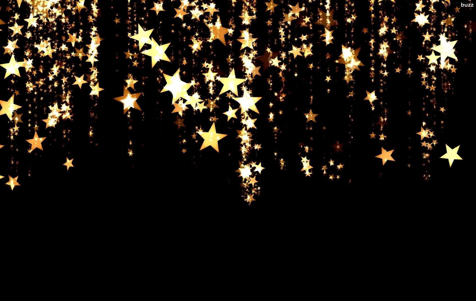 Stars 桌布 壁紙 — 金色星星如閃爍的雨點般傾瀉在深黑色背景上，營造出神奇的節日氣氛。