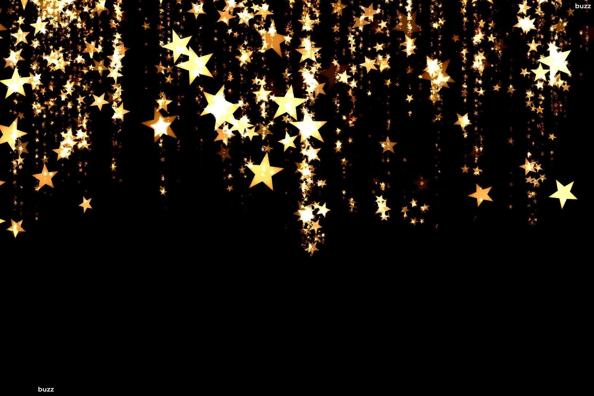 Gold Stars 桌布 壁紙 — 金色星星如閃爍的雨點般傾瀉在深黑色背景上，營造出神奇的節日氣氛。