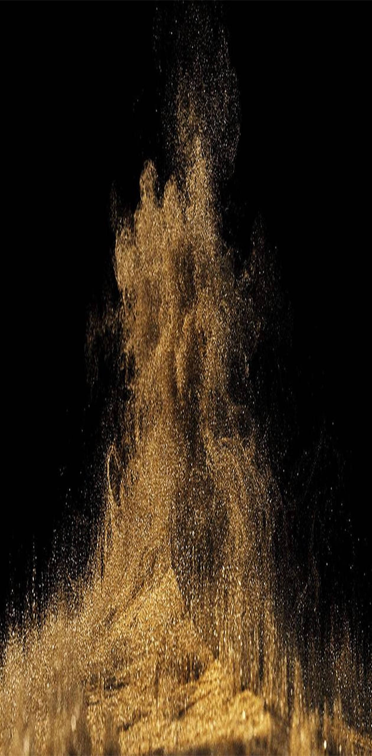 Dust 桌布 壁紙 — 金色沙粒在純黑背景上向上猛烈爆發。