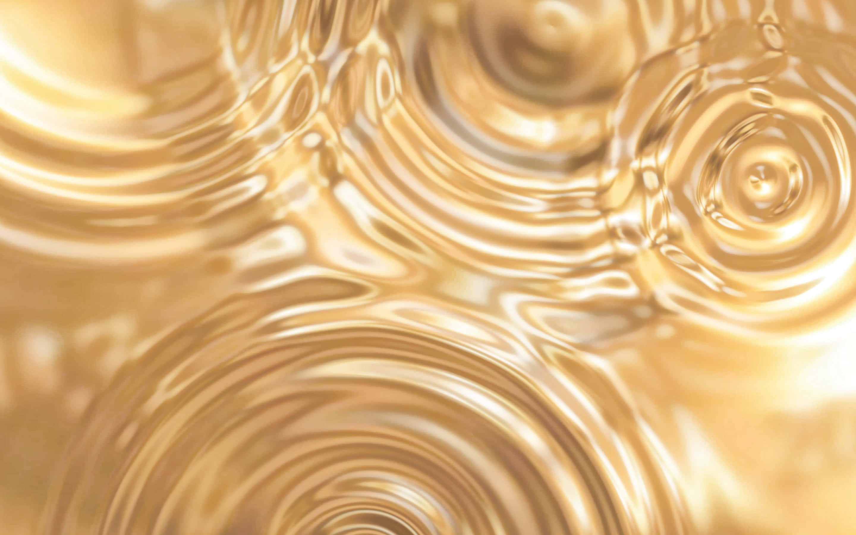 Ripples 桌布 壁紙 — 金色液體漣漪在同心圓中旋轉，營造出帶有柔和亮點的奢華抽象圖案。
