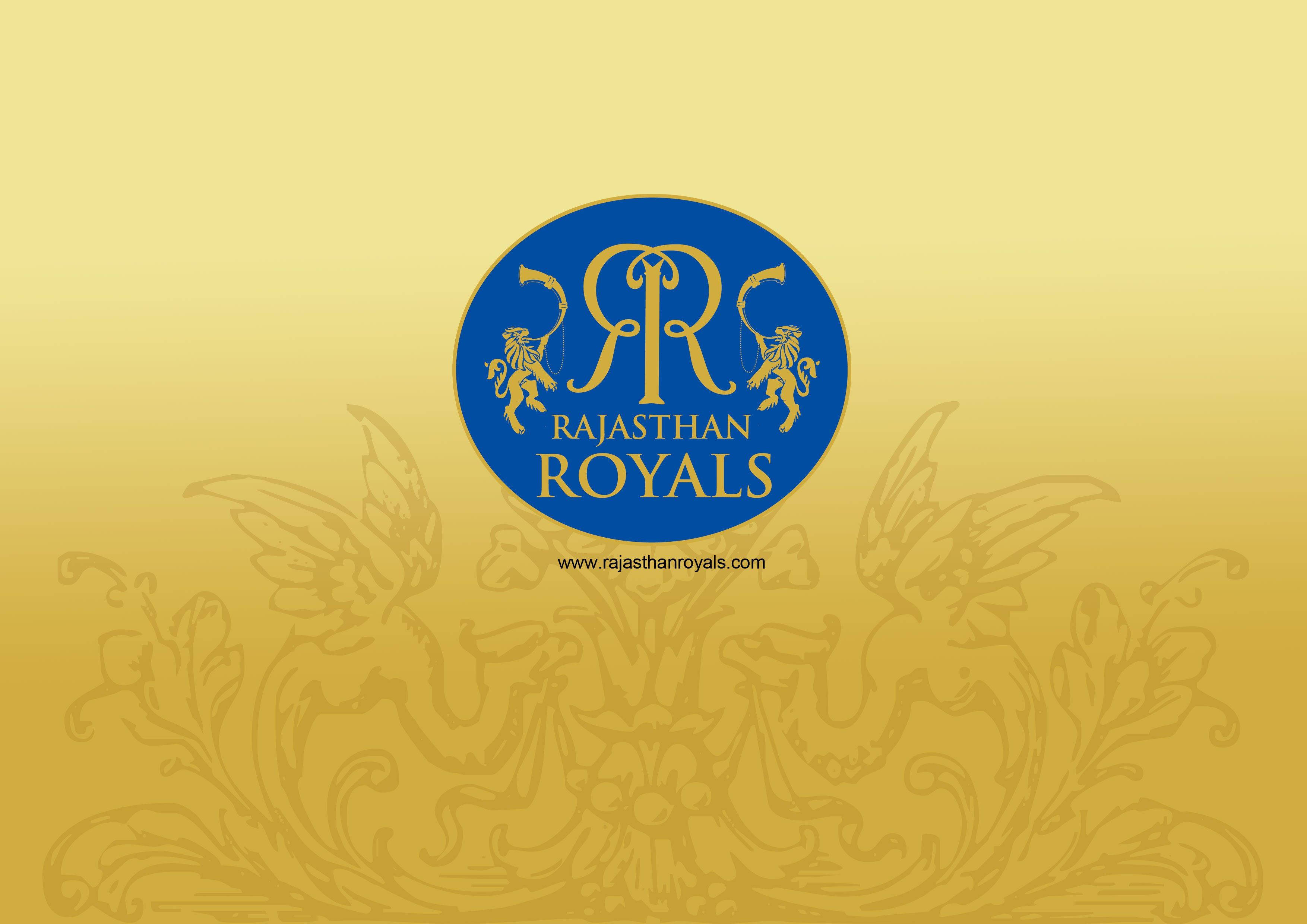 Rajasthan 桌布 壁紙 — 金色漸層背景上展示拉賈斯坦皇家隊標誌，兩側有獅子環繞著風格化的「RR」字母組合。