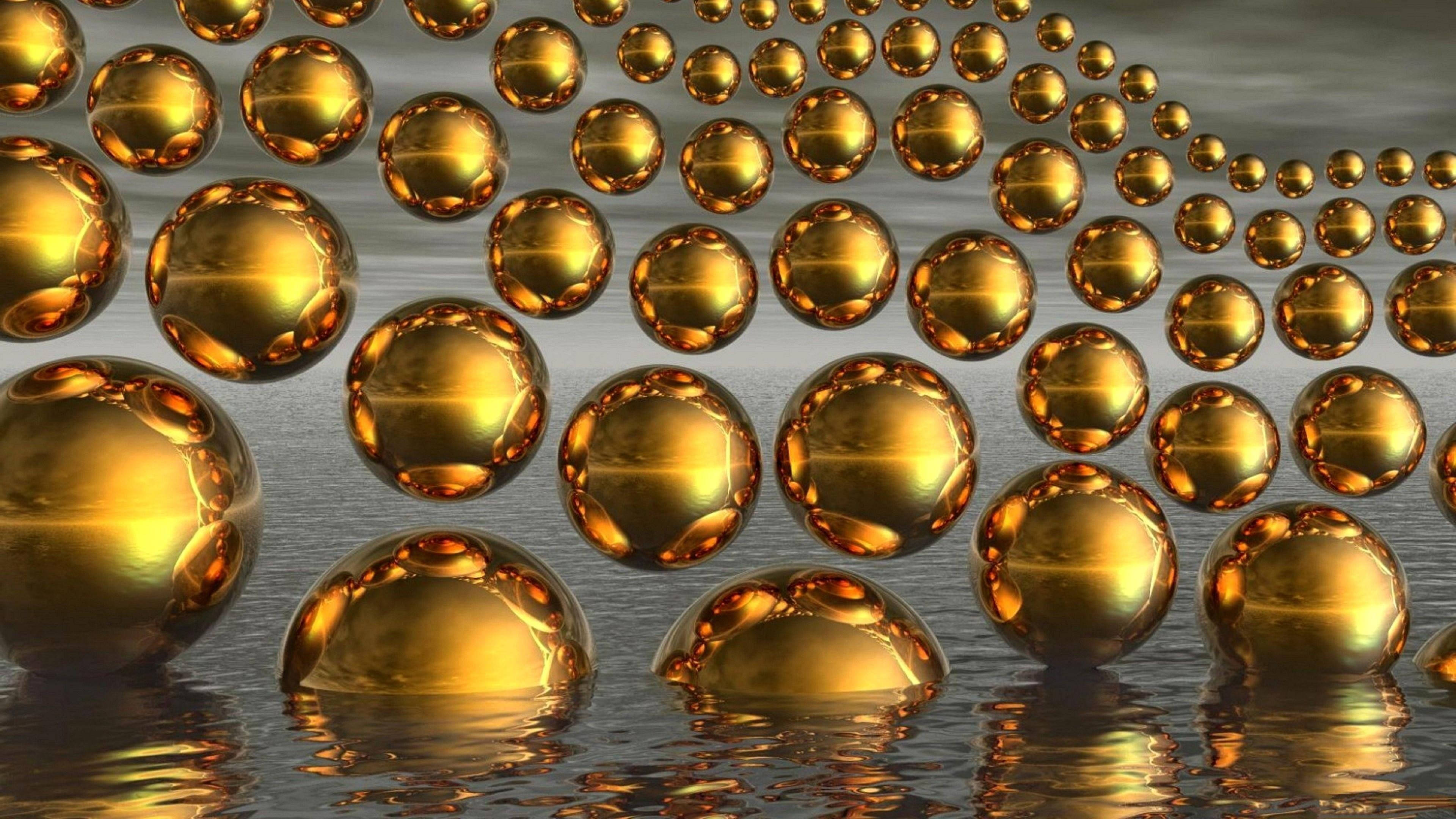balls 桌布 壁紙 — 金色球體漂浮並反射在漣漪水面上，營造出迷人的數位抽象場景。