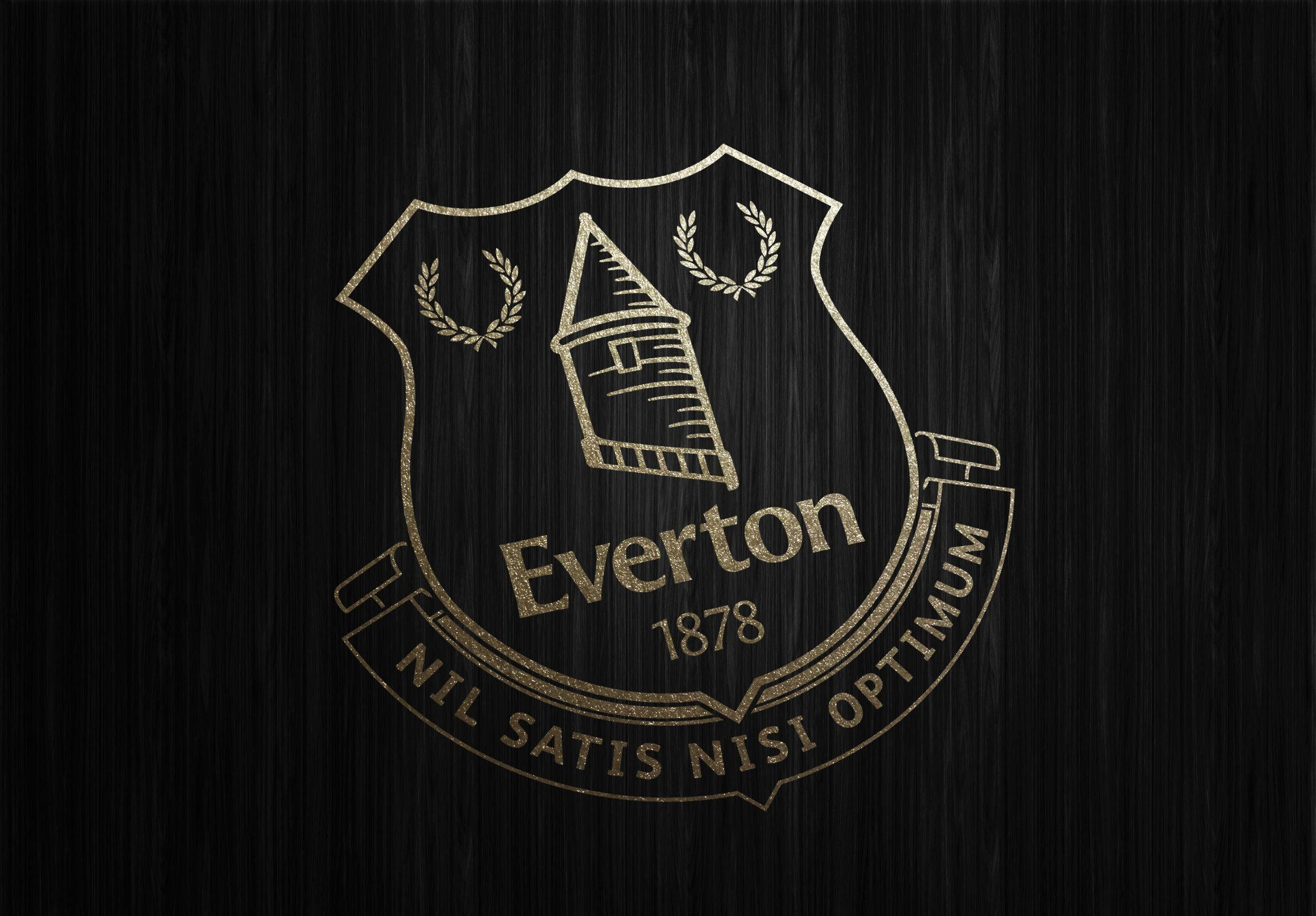 Everton 桌布 壁紙 — 金色的艾佛頓FC會徽，帶有塔樓和月桂花環，在紋理黑色背景上閃耀。