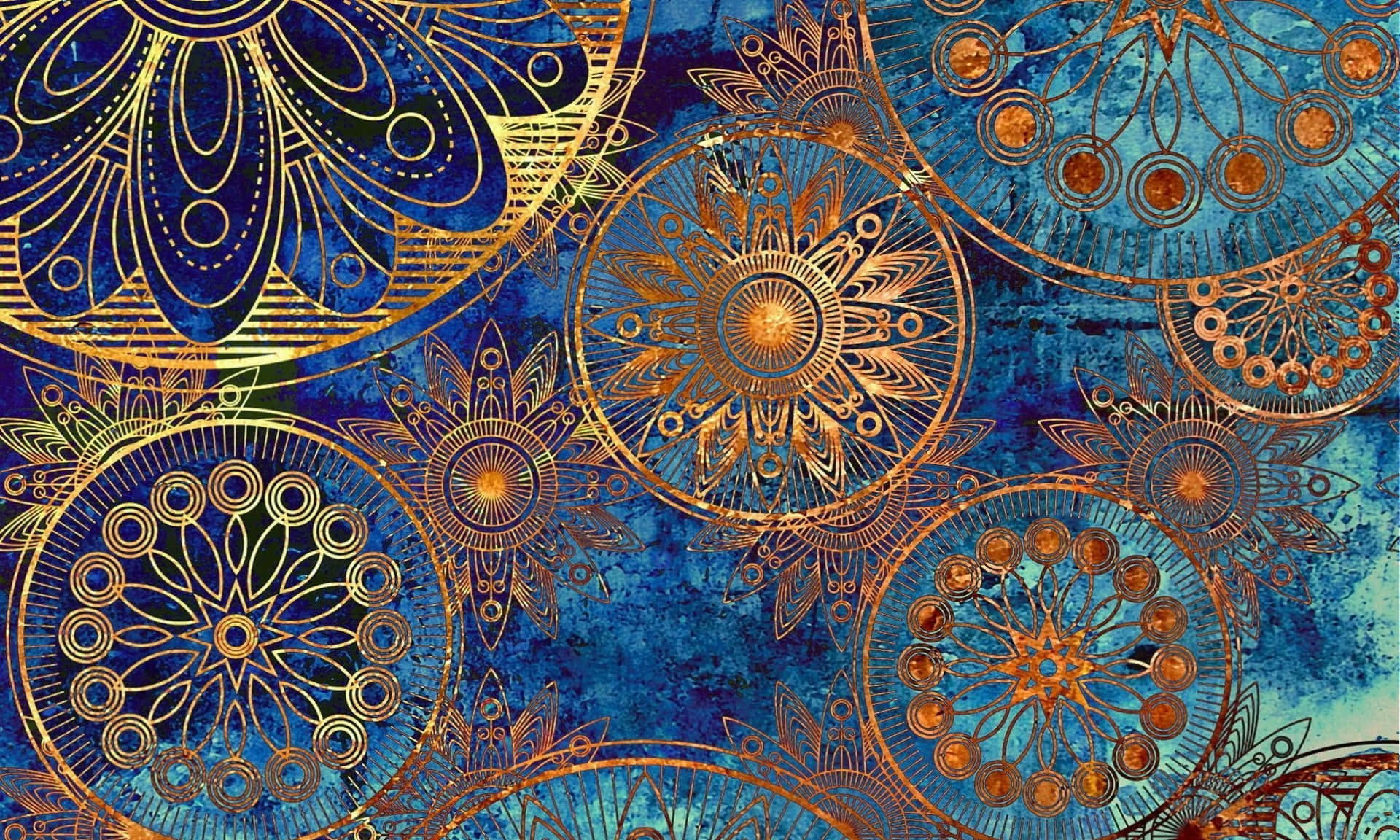 Pattern Desktop 桌布 壁紙 — 金色華麗的曼陀羅圖案漂浮在帶有紋理的深藍色水彩背景上。