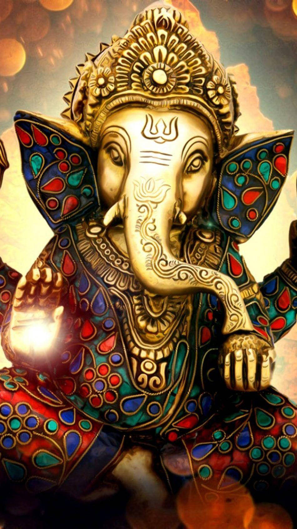 god mobile 桌布 壁紙 — 金色象神雕像飾以彩色寶石圖案，在溫暖的散景背景下散發神聖光芒。
