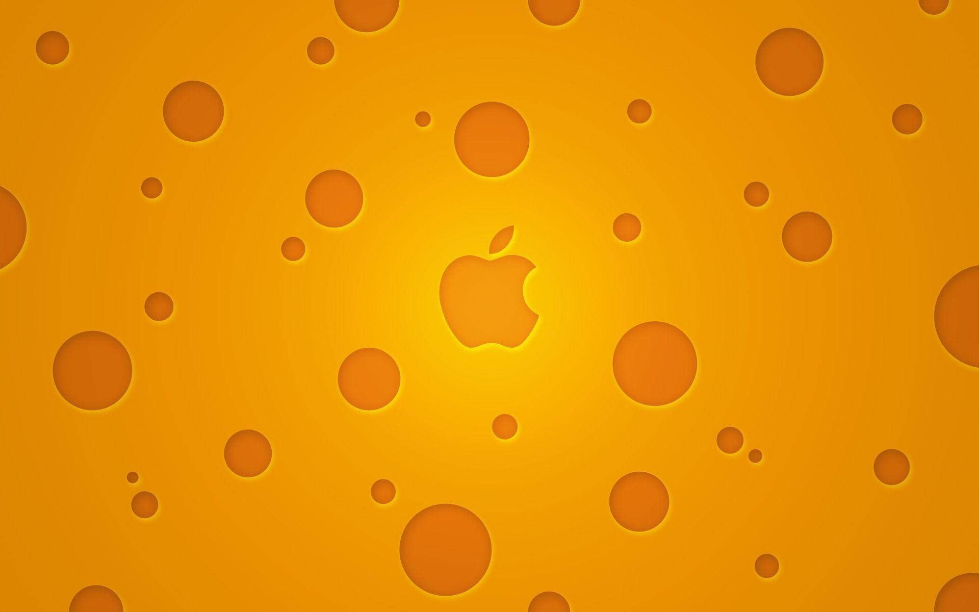 烹飪 桌布 壁紙 — 金色起司紋理背景，中央有一個發光的Apple標誌，周圍有孔洞。