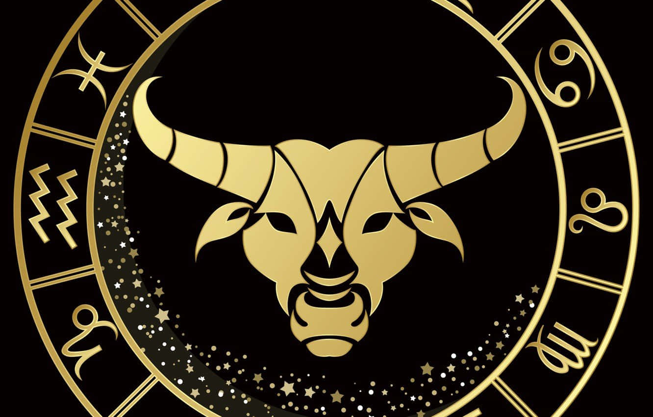 taurus 桌布 壁紙 — 金色金牛座星座符號，帶有星光光環，置於黑色背景的圓形黃道輪中央。