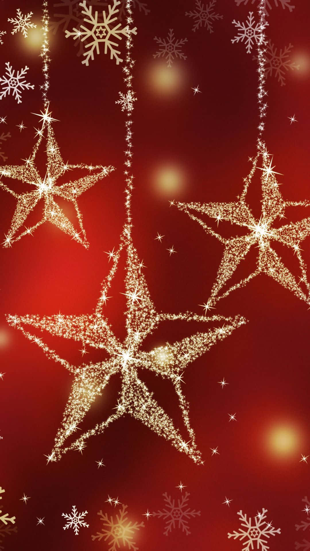 Christmas Star 桌布 壁紙 — 金色閃爍的星星和雪花懸掛在豐富的紅色漸變背景上，帶有柔和發光球體。