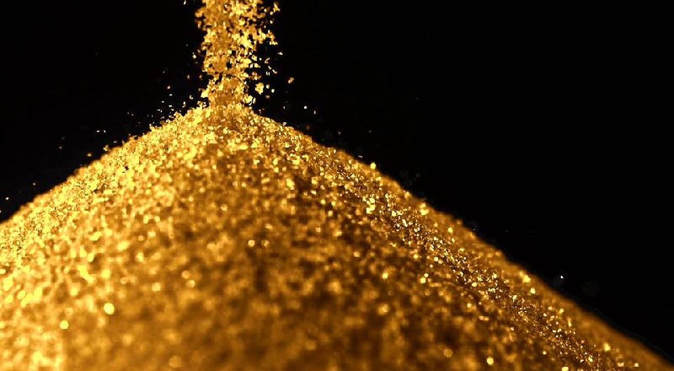 Dust 桌布 壁紙 — 金色閃粉在純黑背景上以慢動作傾瀉而下，營造出閃爍耀眼的效果。