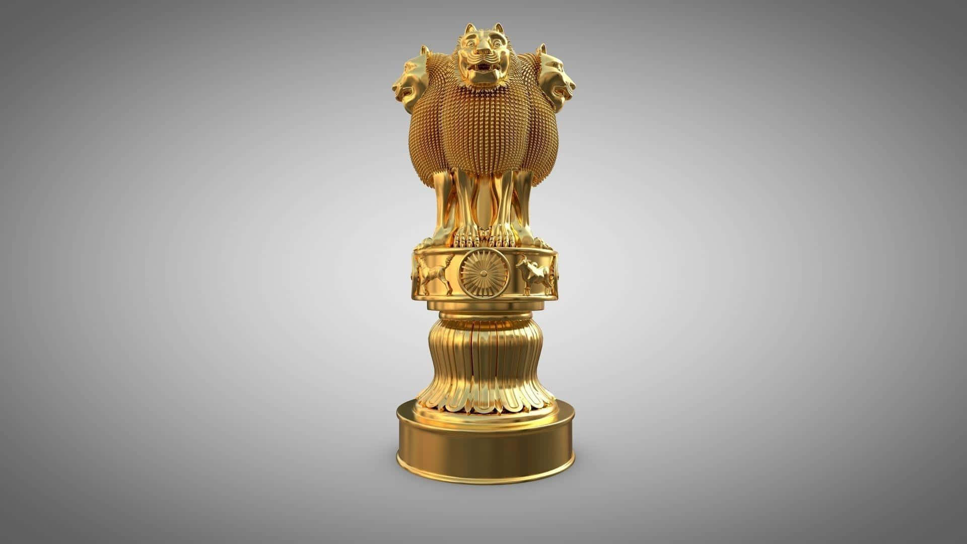 statue 桌布 壁紙 — 金色阿育王法輪標誌，上有四隻獅子，矗立在帶凹槽的基座上，背景為柔和的灰色漸層。