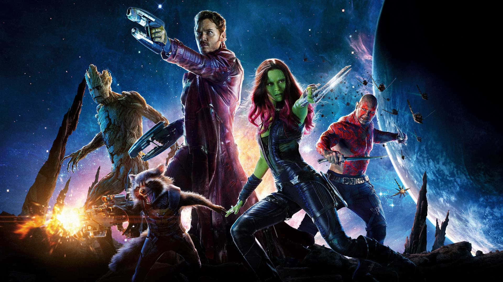 Best Marvel 桌布 壁紙 — 銀河守護者英勇地站在一個岩石外星行星上，背景是星光燦爛的宇宙天空，身後有發光的爆炸。