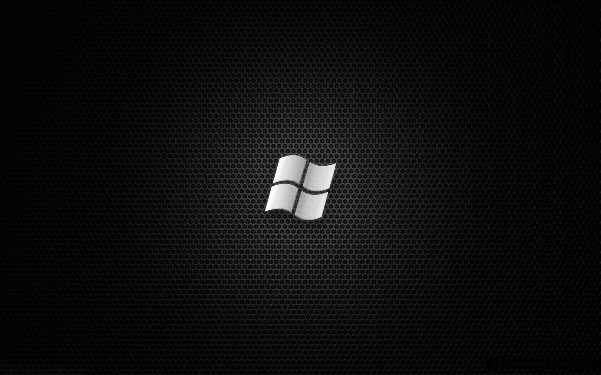 黑色 Windows 10 桌布 壁紙 — 銀色Windows標誌居中於黑色穿孔金屬紋理背景上。