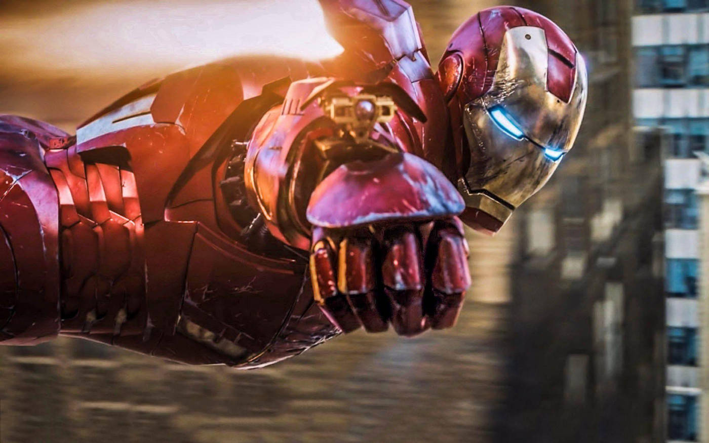 tony stark 桌布 壁紙 — 鋼鐵人帶著發光的衝擊波和堅定的表情飛越城市天際。