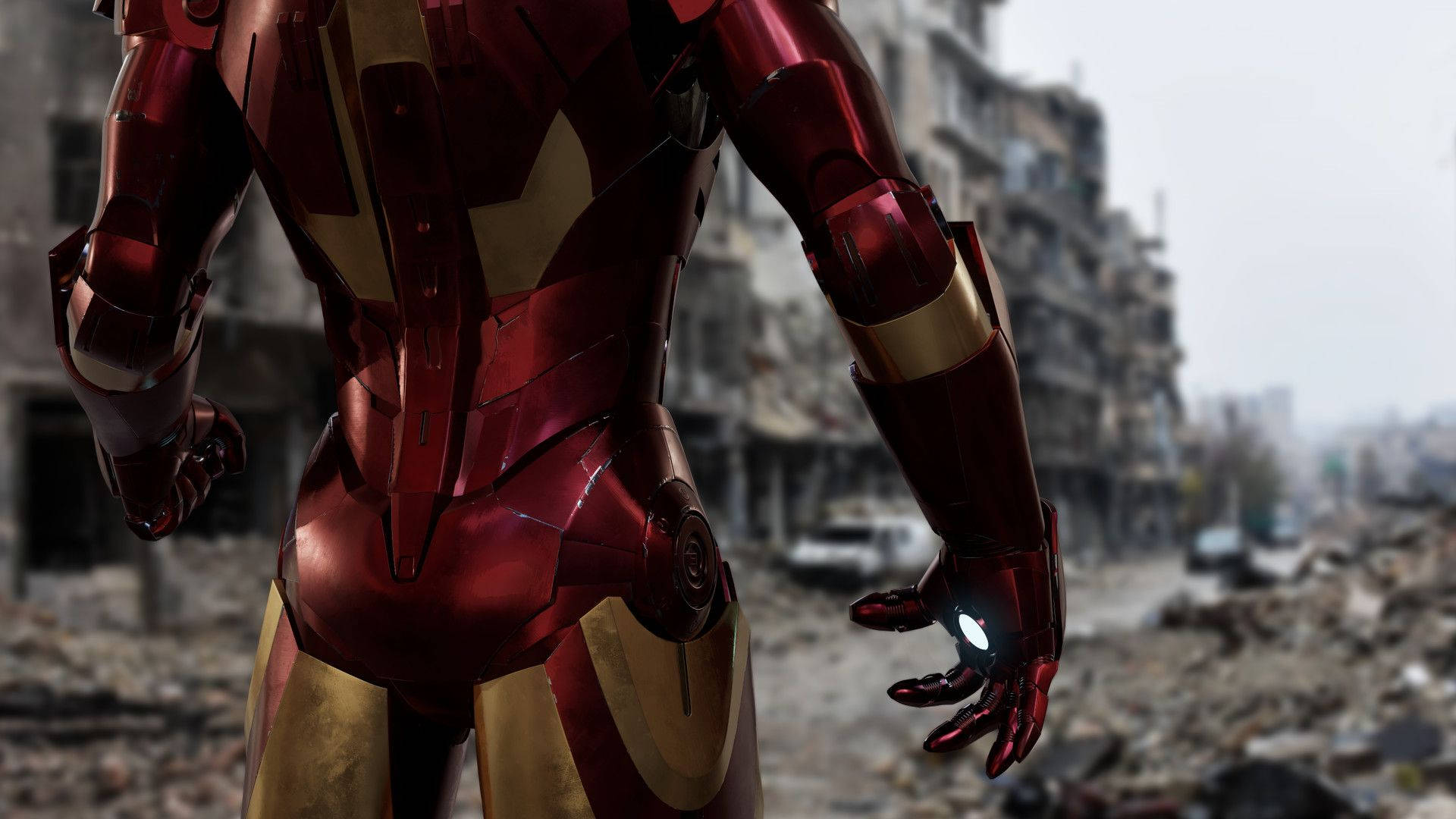 Iron Man Mark 3 桌布 壁紙 — 鋼鐵人站在廢墟城市景觀中，發光的手掌衝擊波準備就緒。