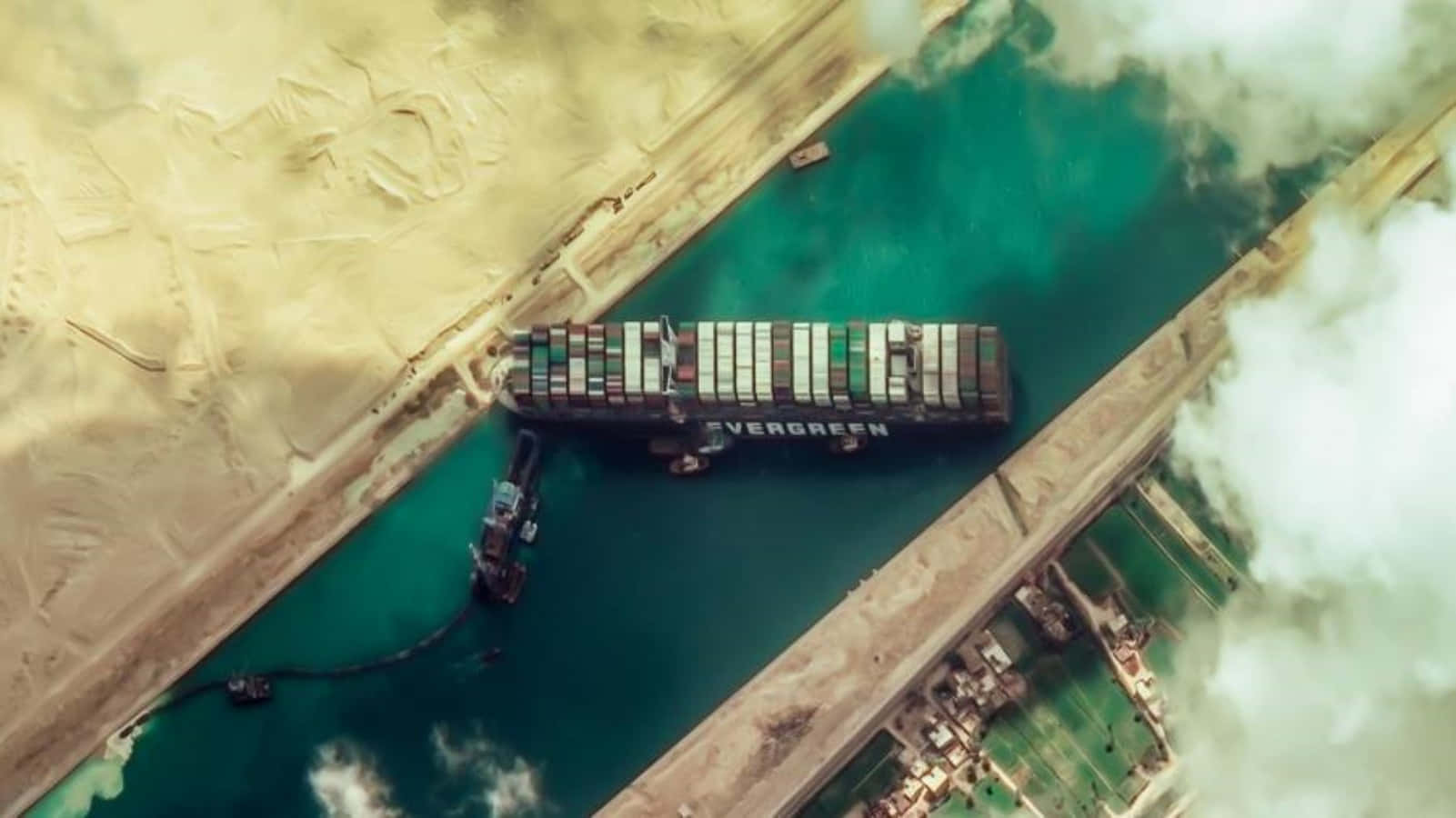 Cargo Ship 桌布 壁紙 — 長榮貨櫃輪在蘇伊士運河橫向擱淺，拖船正在努力將其解救的航拍圖。