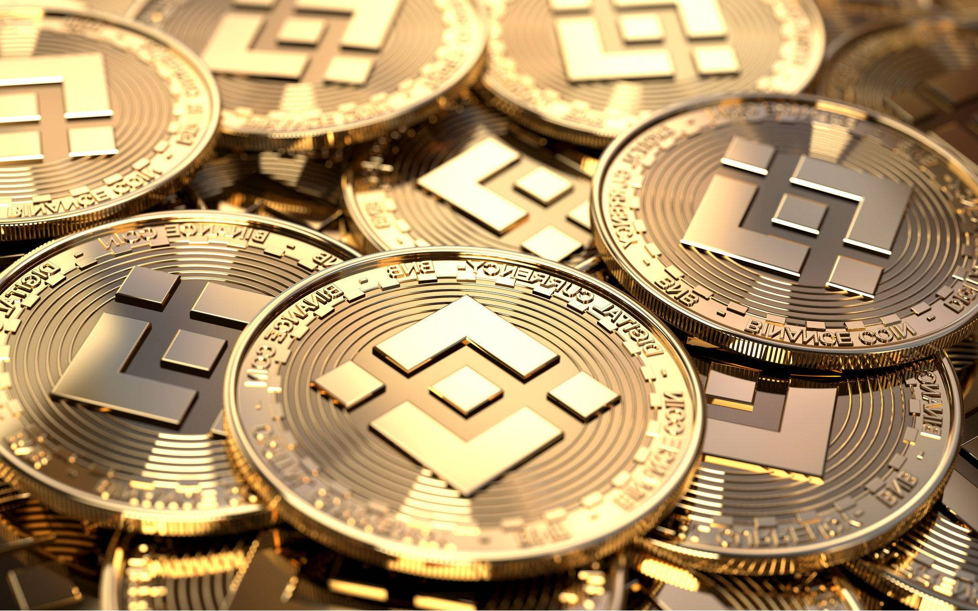 Binance 桌布 壁紙 — 閃亮的金色Litecoin硬幣堆疊在一起，帶有精細雕刻和金屬反射。