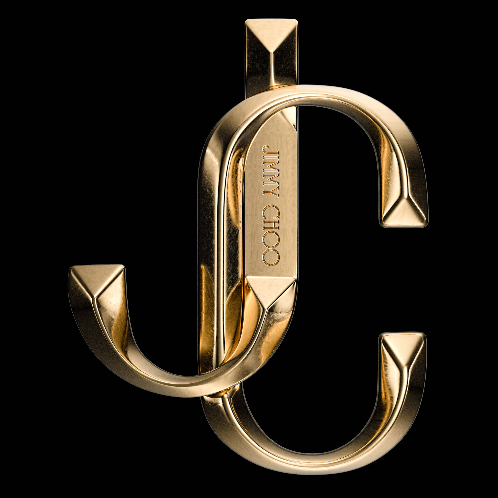 Brand 桌布 壁紙 — 閃亮的金色互鎖JC標誌，帶有雕刻文字，在純黑背景上脫穎而出。