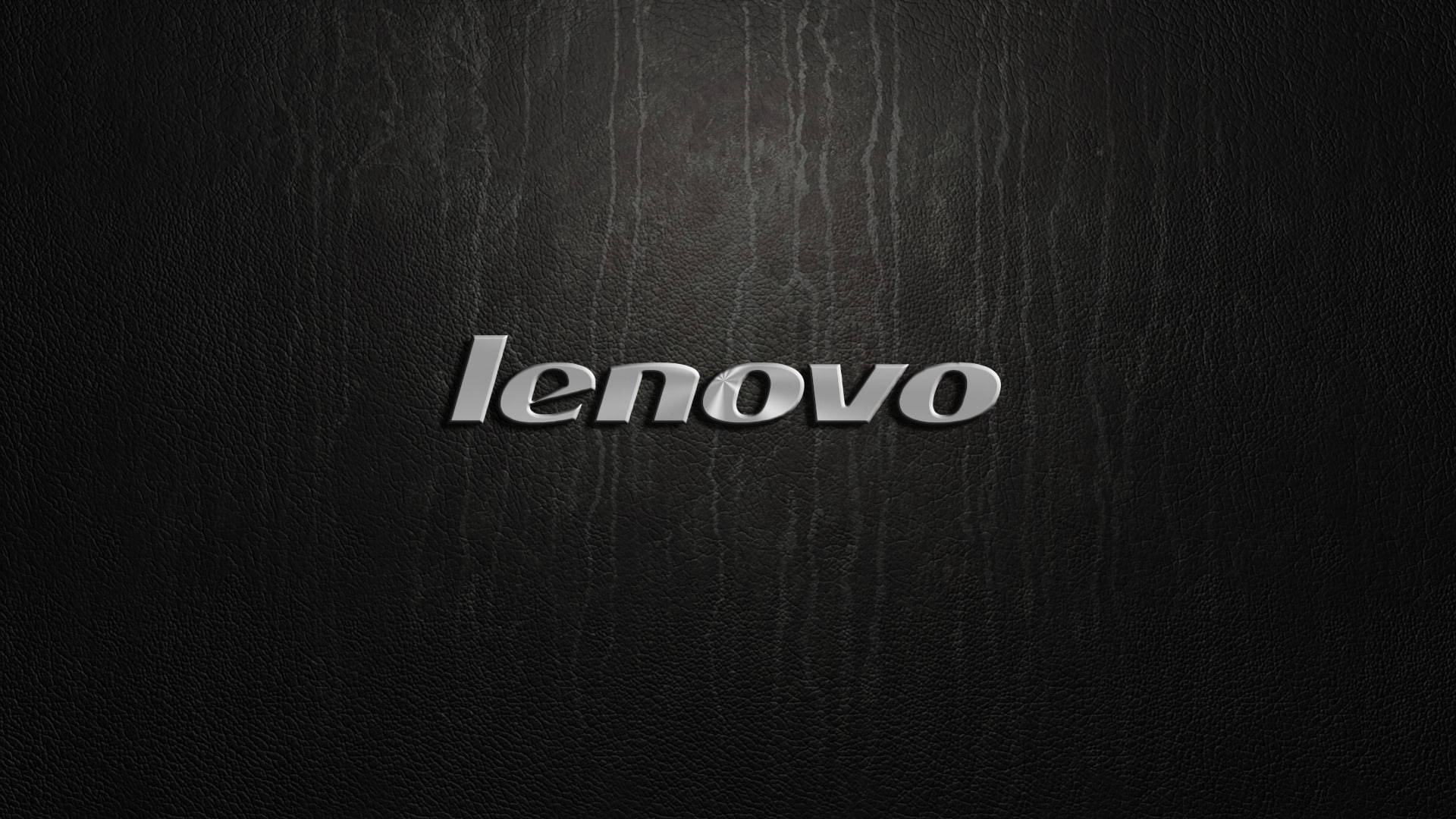 黑色皮革紋理上的閃亮銀色 Lenovo 標誌。 — 聯想高畫質桌布 壁紙