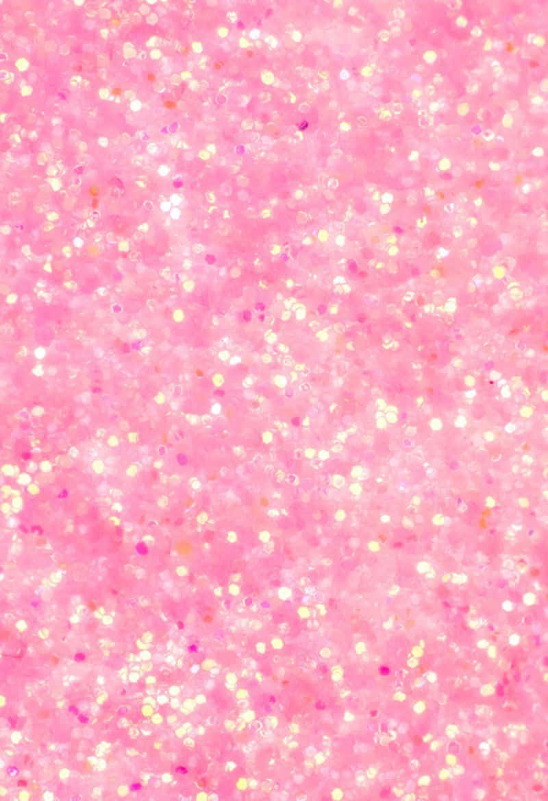 Pink Sparkly 桌布 壁紙 — 閃爍的粉紅色閃粉紋理，帶有散落的白金色和紫色斑點，營造出閃亮的抽象表面。