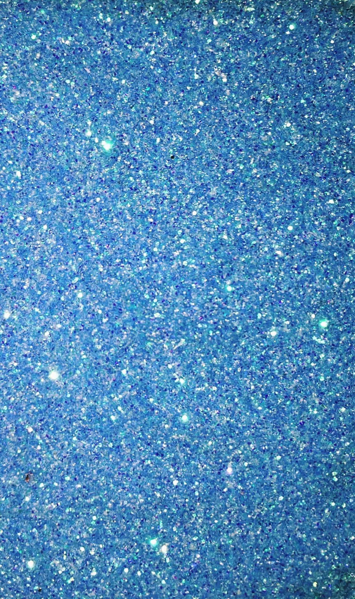 Shimmer 桌布 壁紙 — 閃爍的藍色亮片紋理，帶有閃爍的顆粒在表面捕捉光線。