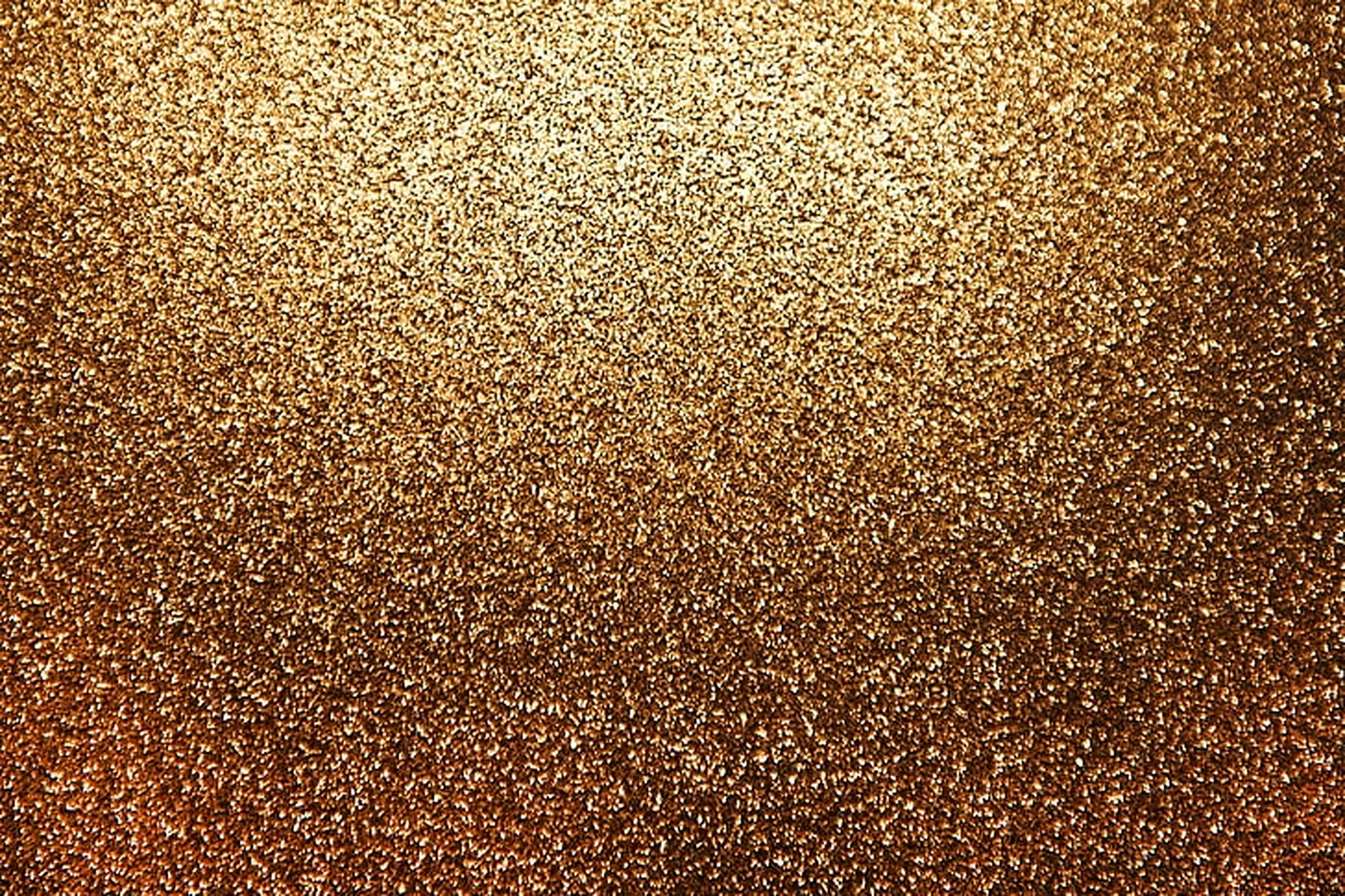 Dust 桌布 壁紙 — 閃爍的金色亮粉粒子漸變，從明亮的頂部過渡到深古銅色底部。