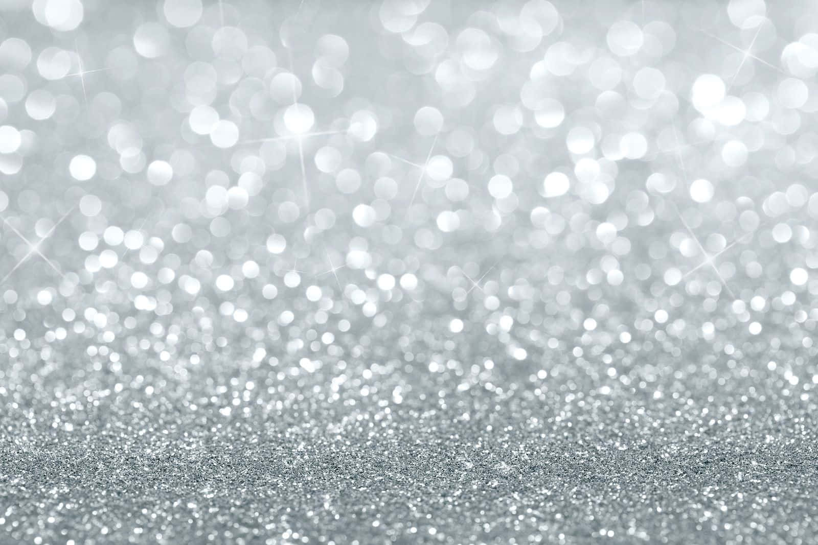 閃爍的銀色亮粉，帶有柔和發光的散景光。 — 閃爍 GIF 壁紙