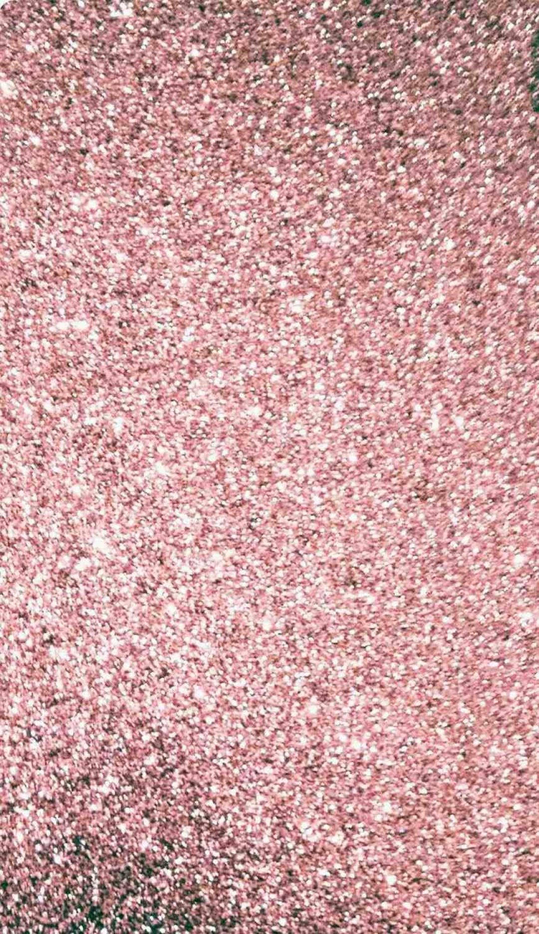 Pink iPhone Xr 桌布 壁紙 — 閃爍粉紅亮片的特寫，帶有散落的白色和深色斑點，營造出閃閃發光的紋理表面。