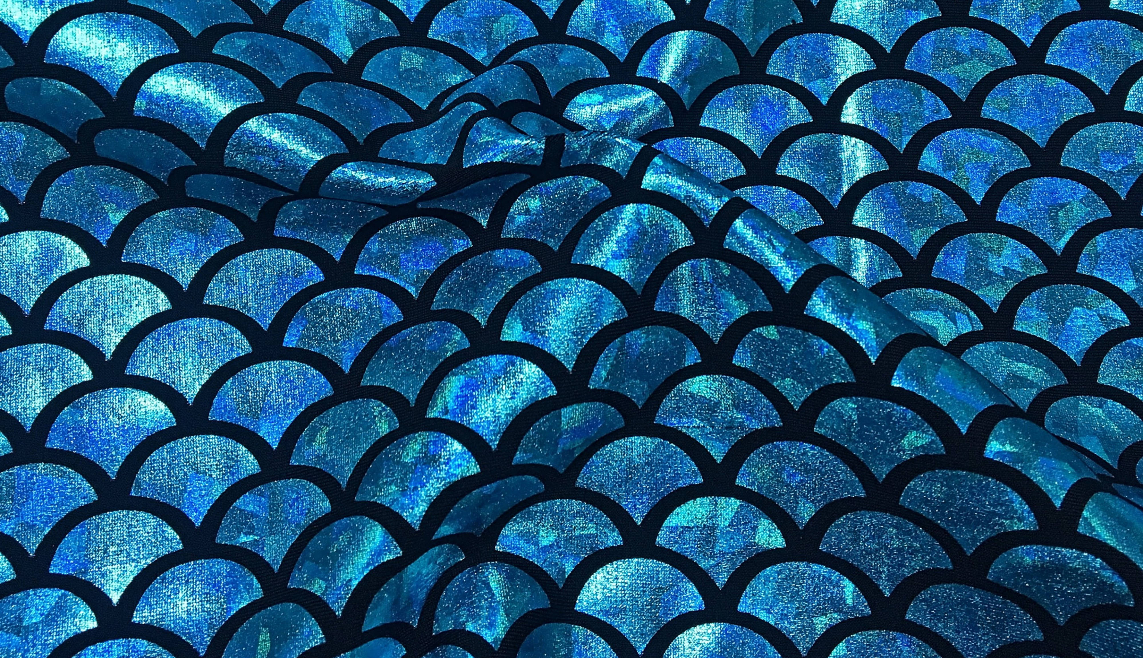 Holographic 桌布 壁紙 — 閃爍藍色美人魚鱗片布料的特寫，帶有粗黑輪廓和紋理金屬光澤。