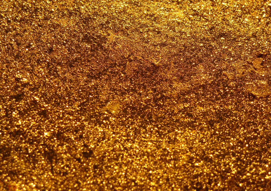 Orange Glitter 桌布 壁紙 — 閃爍金色亮片的特寫，帶有閃亮顆粒和紋理表面。