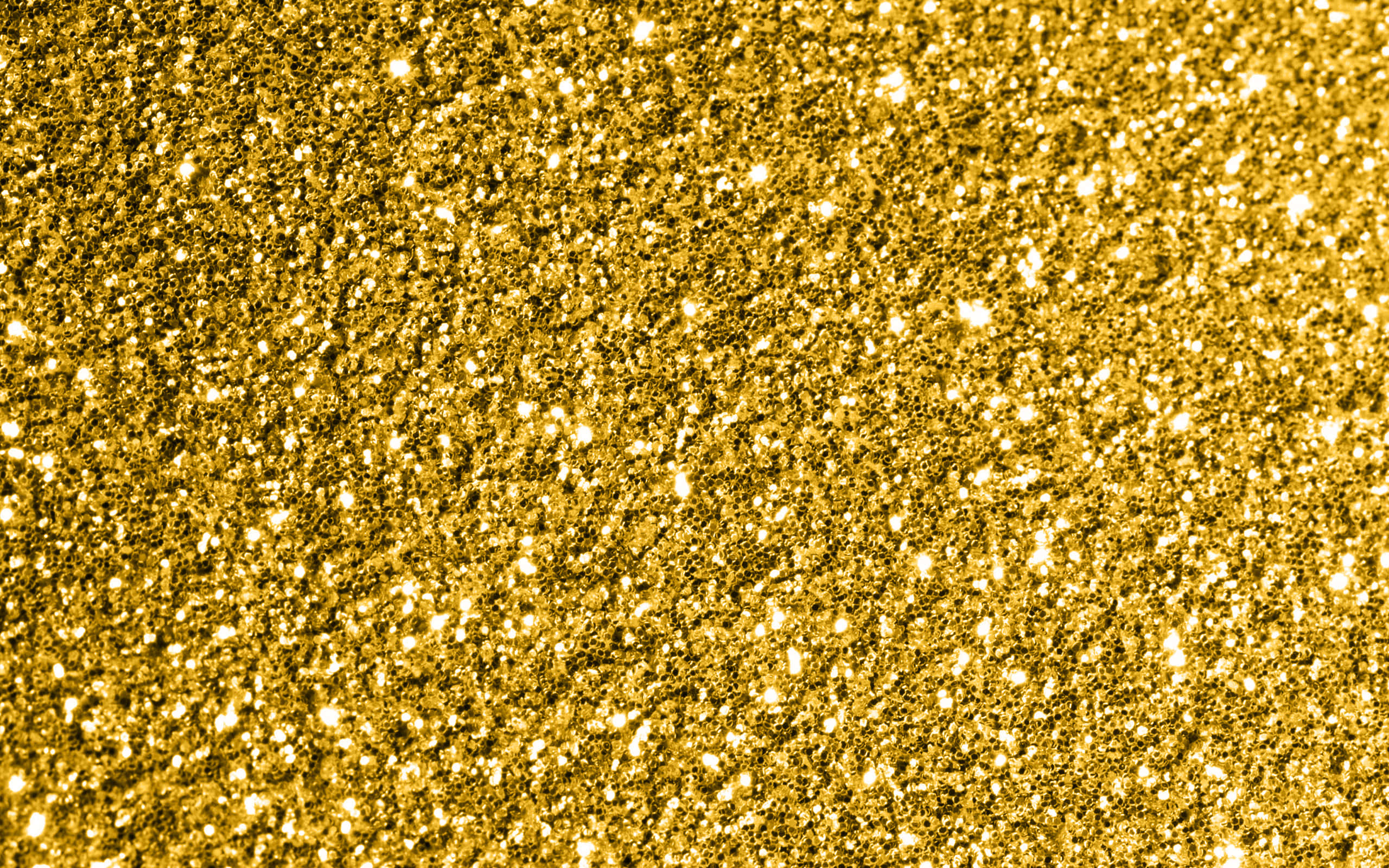 High Resolution Gold Glitter 桌布 壁紙 — 閃爍金色亮片的特寫，明亮的閃光在紋理表面上捕捉光線。