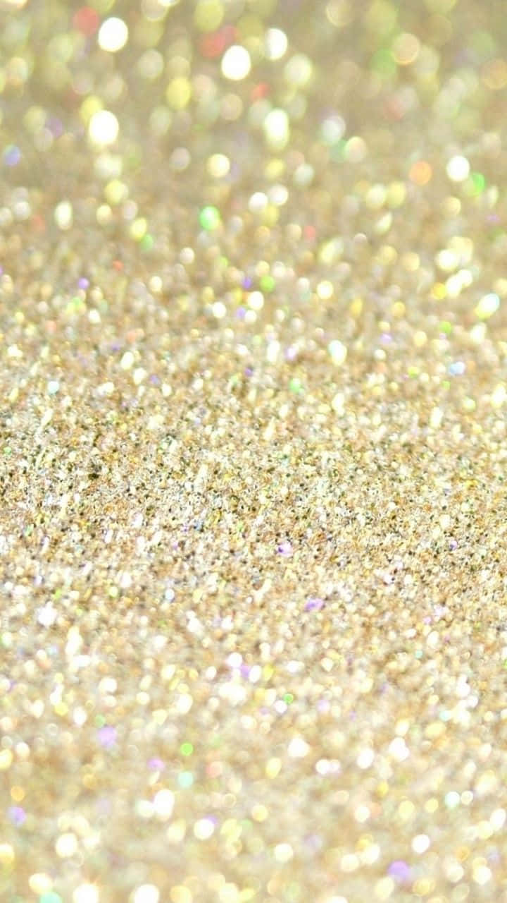 Sparkly 桌布 壁紙 — 閃爍金色亮粉的特寫，帶有柔和散景高光，營造出閃閃發光的紋理表面。