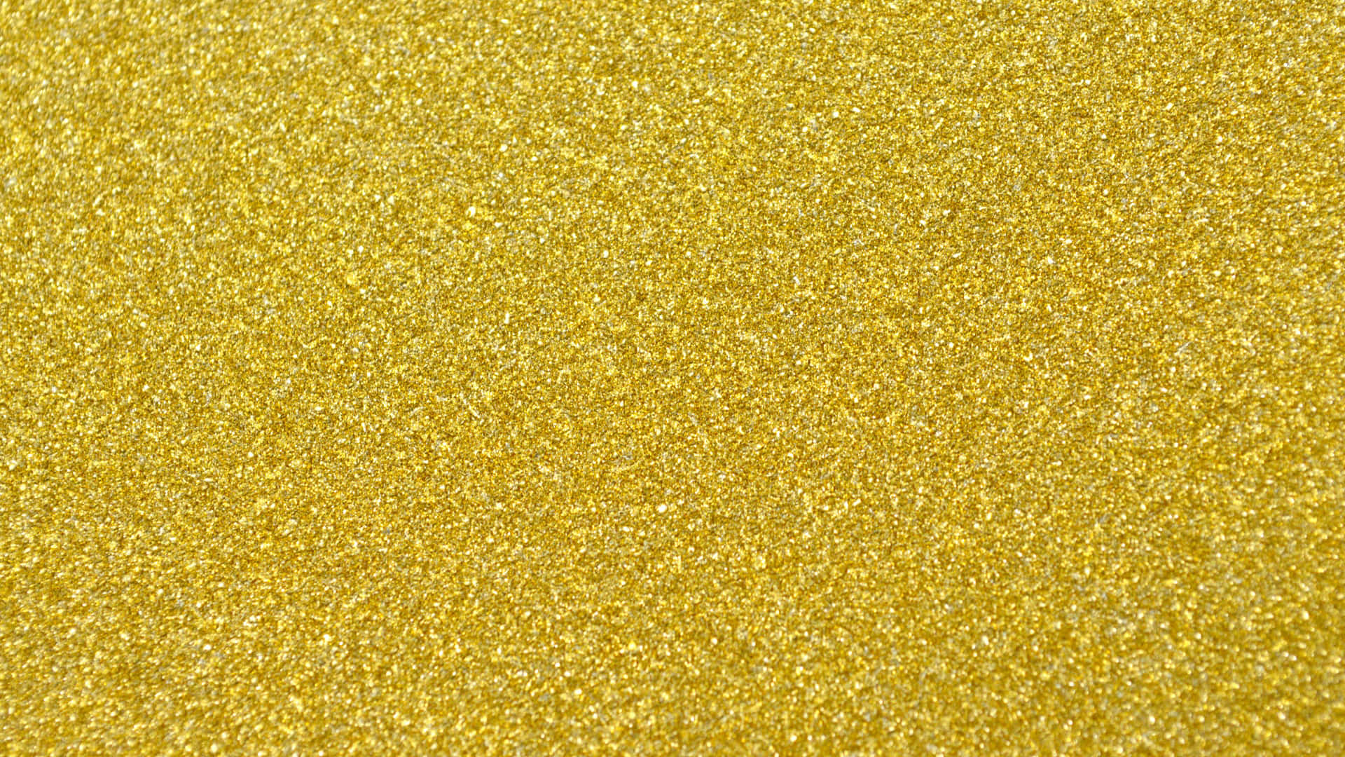 Yellow Glitter 桌布 壁紙 — 閃爍金色閃粉質感的特寫，帶有捕捉光線的閃亮粒子。