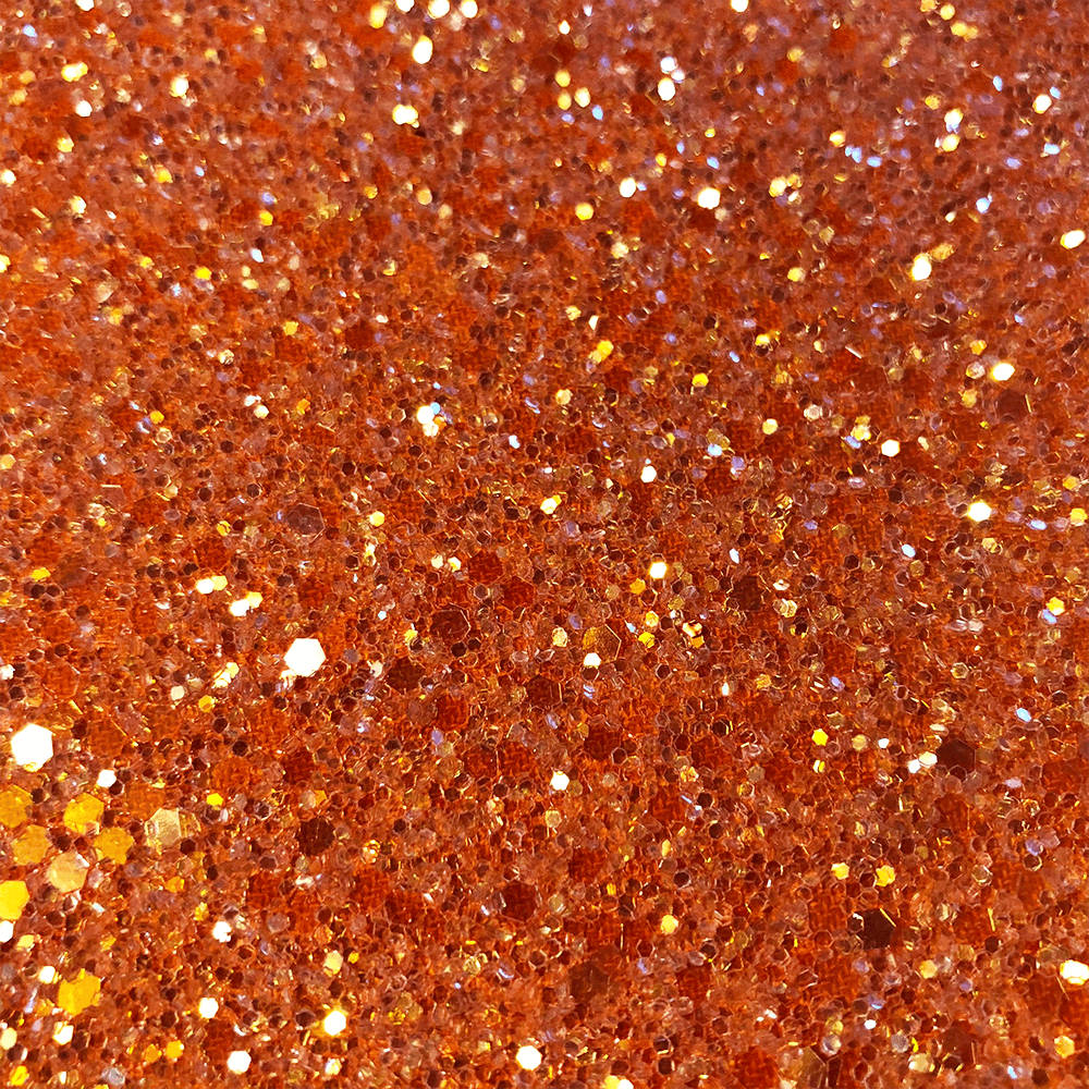 Sparkly 桌布 壁紙 — 閃爍銅色和金色亮粉的特寫，營造出帶有反射高光的閃亮紋理表面。