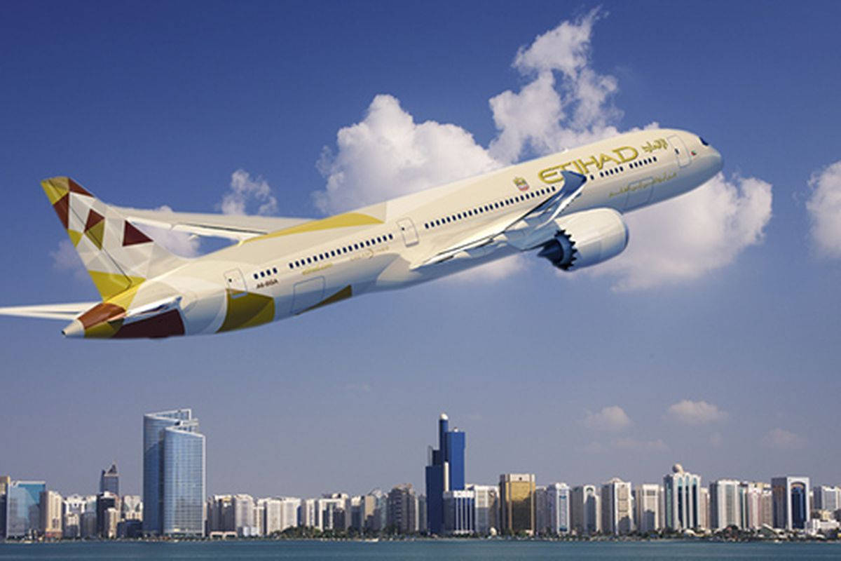 flying 桌布 壁紙 — 阿提哈德航空的飛機在明亮的藍天白雲下，翱翔於現代城市天際線之上。